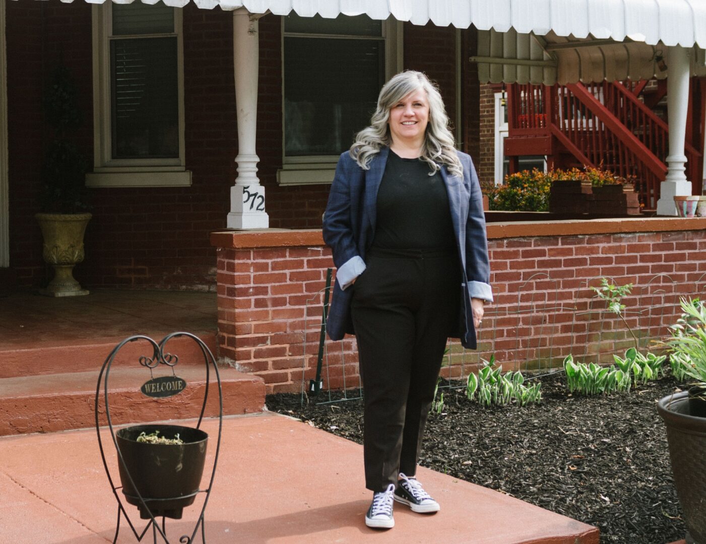Jennifer Lopez, CEO stands in front of NIA House