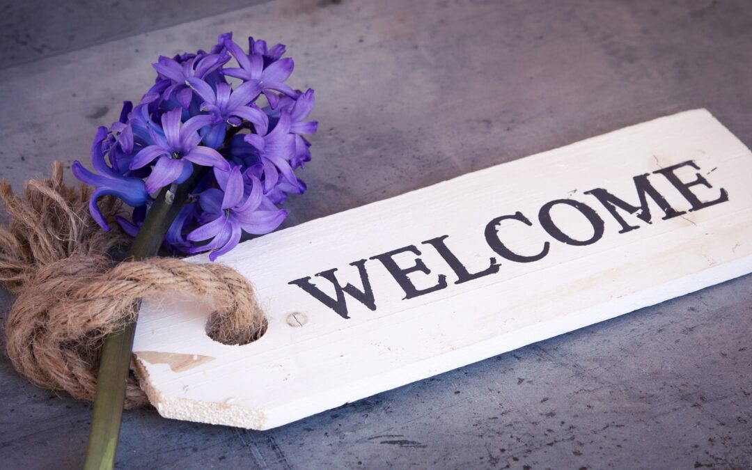 a welcome sign with flowers